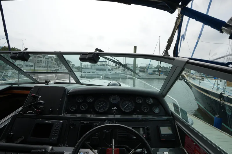 Slide: The Image of Cockpit view of a 1993 Sea Ray 400 Express Cruiser at a marina. - 14