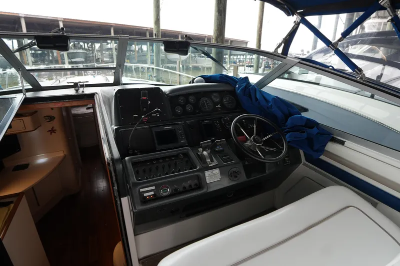 Slide: The Image of 1993 Sea Ray 400 Express Cruiser helm with navigation controls and seating. - 2