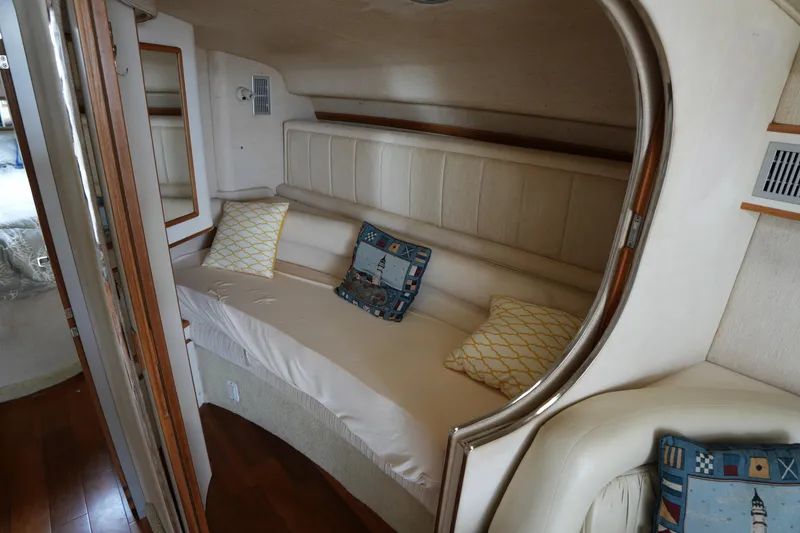 Slide: The Image of Interior of 1993 Sea Ray 400 Express Cruiser with cozy seating and decorative pillows. - 20
