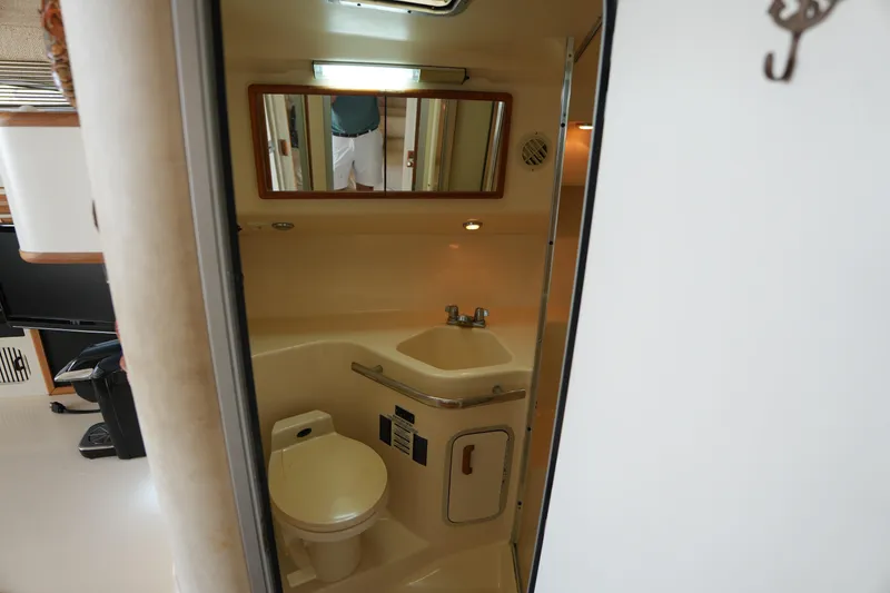 Slide: The Image of Bathroom interior of 1993 Sea Ray 400 Express Cruiser with sink and toilet. - 21
