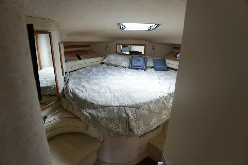 Slide: The Image of Interior cabin of 1993 Sea Ray 400 Express Cruiser with cozy bed and pillows. - 23