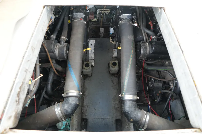 Slide: The Image of Engine compartment of a 1993 Sea Ray 400 Express Cruiser, showcasing mechanical components. - 26