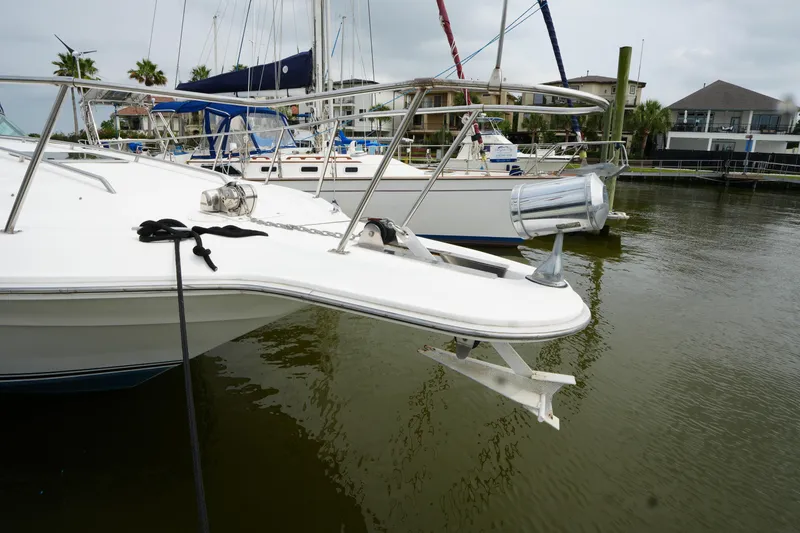 Slide: The Image of 1993 Sea Ray 400 Express Cruiser docked, featuring anchor and railing, in a marina setting. - 5