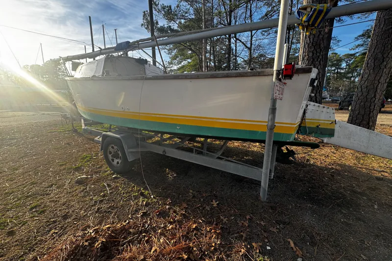 Slide: The Image of 1976 Custom Wooden Sloop on trailer outdoors at sunset. - 10