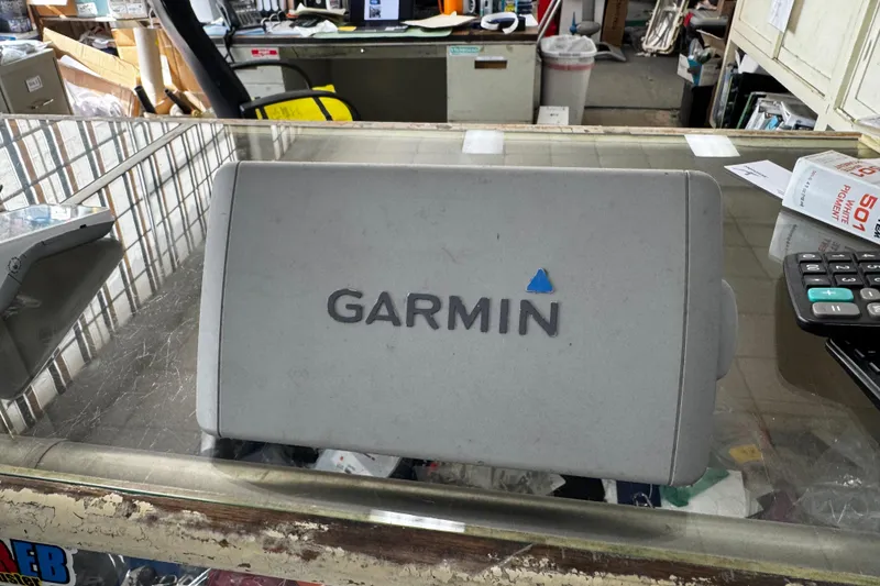Slide: The Image of Garmin device on a glass counter, surrounded by office supplies and papers. - 11
