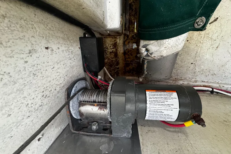 Slide: The Image of Winch mechanism inside a 1976 Custom Wooden Sloop, featuring cables and warning label. - 18