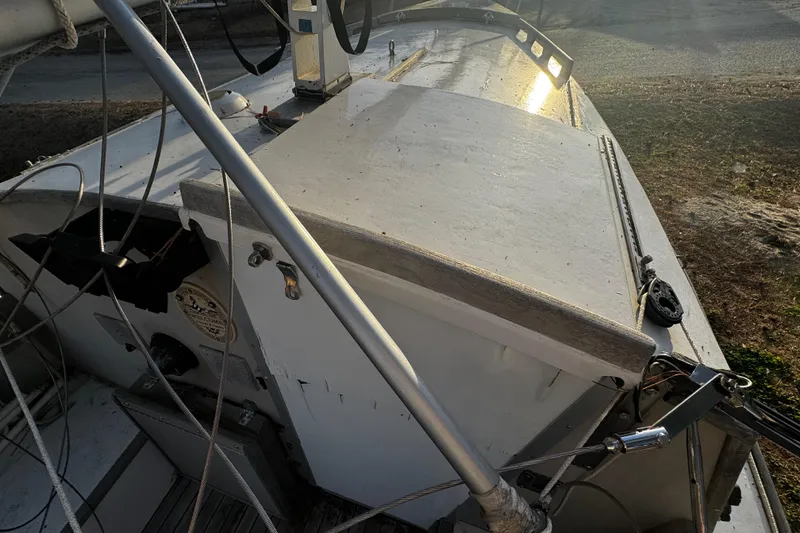 Slide: The Image of 1976 Custom Wooden Sloop deck with rigging and sunlight reflection. - 31