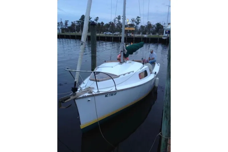Slide: The Image of 1976 Custom 22 Wooden Sloop docked at a marina, calm water, overcast sky. - 36
