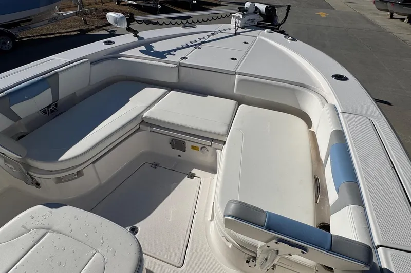 Slide: The Image of 2023 Robalo 266 Cayman boat interior with cushioned seating and storage compartments. - 18