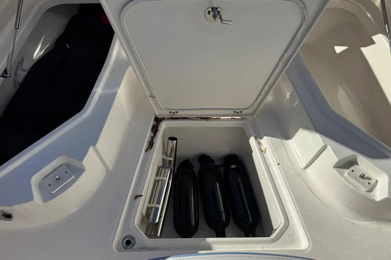 Slide: The Image of 2023 Robalo 266 Cayman boat storage compartment with fenders and accessories. - 19