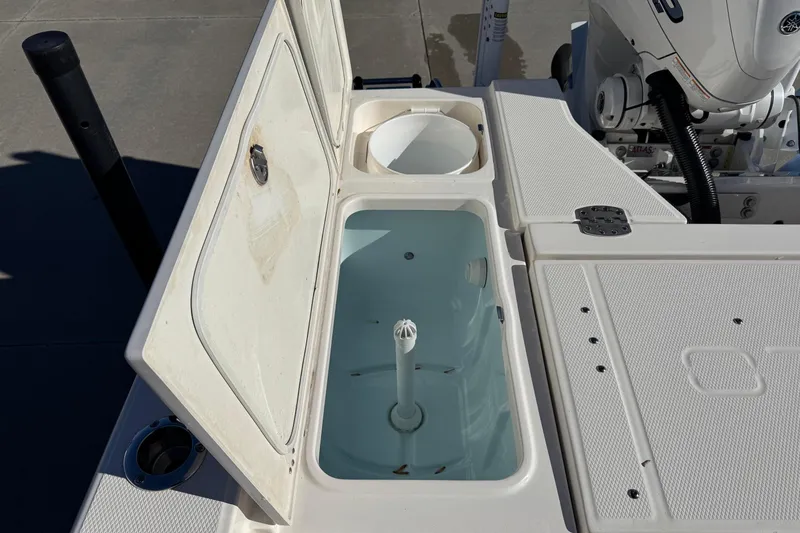 Slide: The Image of 2023 Robalo 266 Cayman boat livewell and storage compartments, open view. - 23