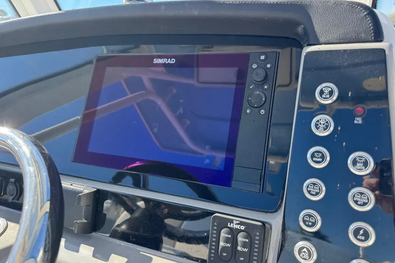 Slide: The Image of Dashboard of 2023 Robalo 266 Cayman with Simrad display and control buttons. - 3
