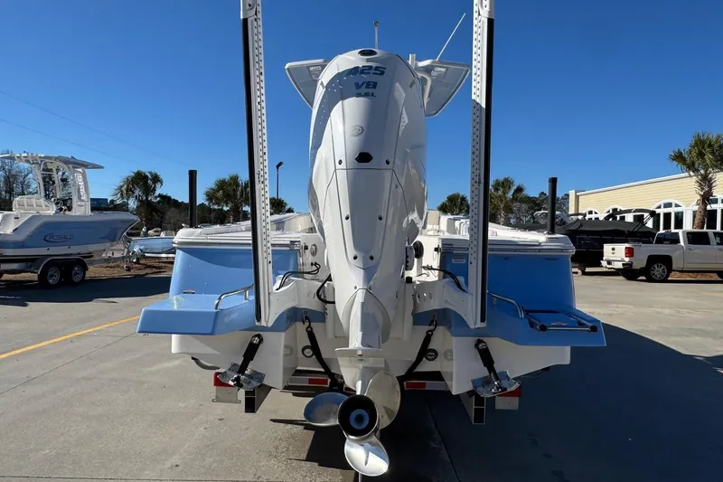 Slide: The Image of 2023 Robalo 266 Cayman boat with powerful V8 engine, parked outdoors. - 5
