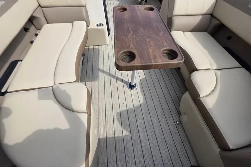 Slide: The Image of 2026 Veranda VR22RC Tri-Toon interior detail with logo on beige upholstery. - 14