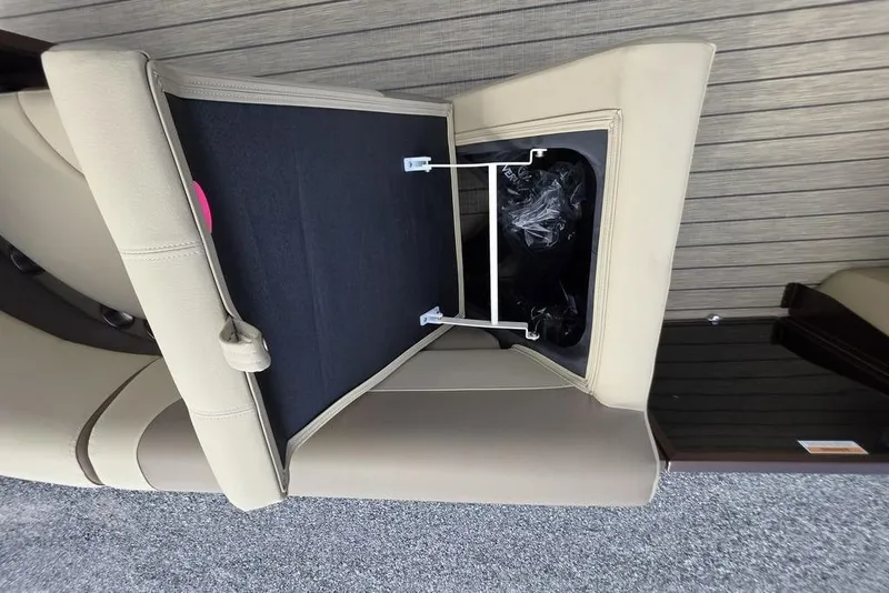 Slide: The Image of Luxurious interior of 2026 Veranda VR22RC Tri-Toon with beige seating and wood-style flooring. - 16