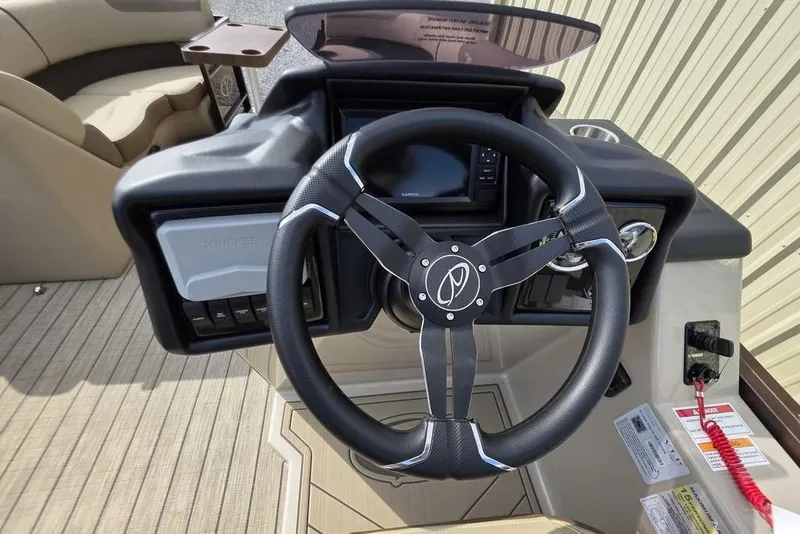 Slide: The Image of 2026 Veranda VR22RC Tri-Toon boat interior with steering console and beige seating. - 22