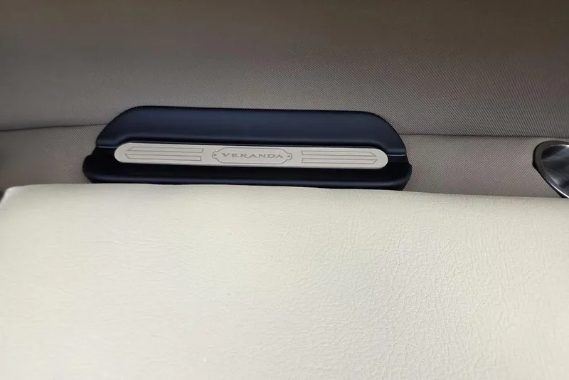 Slide: The Image of Interior storage compartment of 2026 Veranda VR22RC Tri-Toon boat, featuring cup holders. - 25