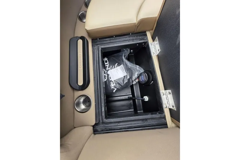Slide: The Image of Interior storage compartment of 2026 Veranda VR22RC Tri-Toon boat with beige seating. - 28