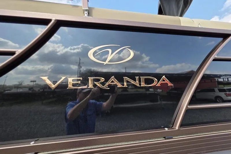 Slide: The Image of 2026 Veranda VR22RC Tri-Toon boat on trailer, sleek design under cloudy sky. - 3