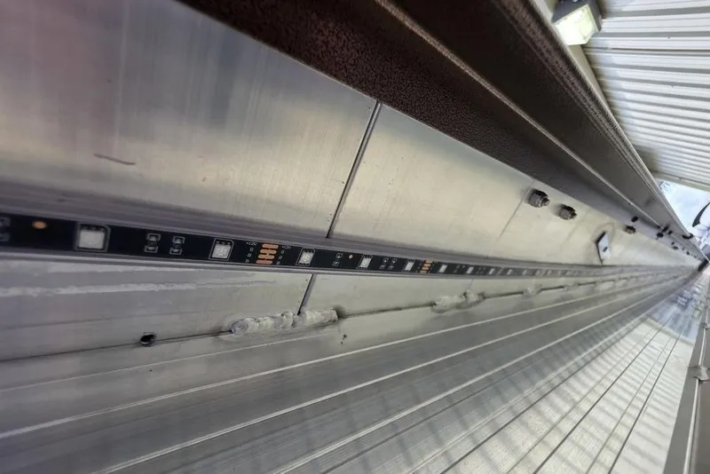 Slide: The Image of 2026 Veranda VR22RC Tri-Toon boat on trailer at Bryan's Marine dealership. - 6