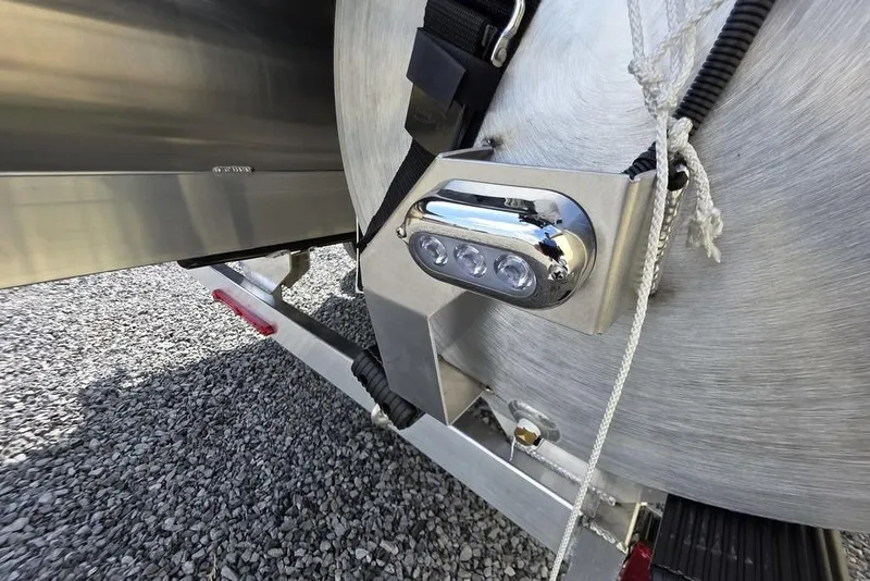 Slide: The Image of 2026 Veranda VR22RC Tri-Toon storage compartment with beige seating and open lid. - 8