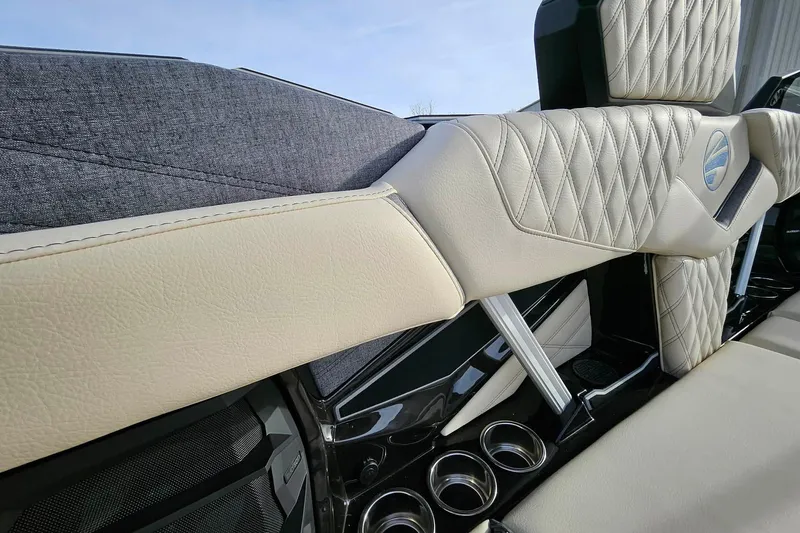 Slide: The Image of Luxurious interior of 2026 Tigé 24RZX boat with diamond-stitched upholstery and cup holders. - 11
