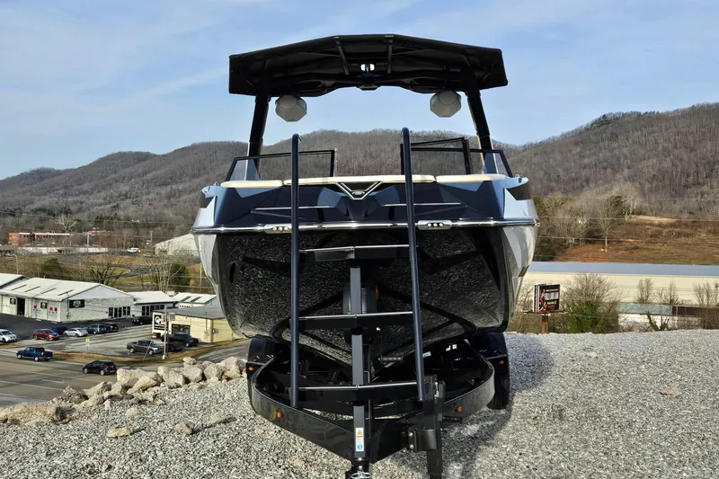 Slide: The Image of 2026 Tigé 24RZX boat on trailer, mountainous backdrop, dealership setting. - 18