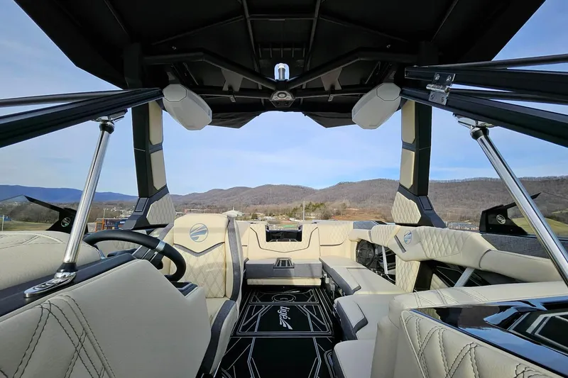 Slide: The Image of Luxurious interior of 2026 Tigé 24RZX boat with scenic mountain backdrop. - 25
