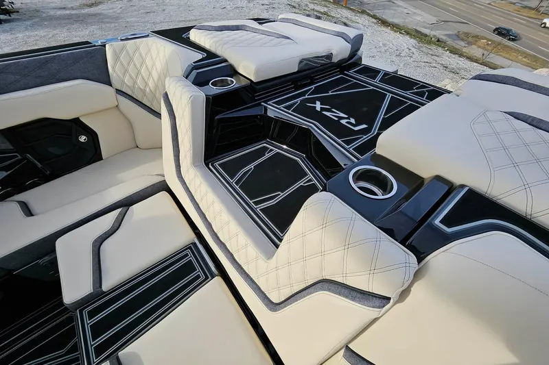 Slide: The Image of Luxurious interior of 2026 Tigé 24RZX boat with stylish seating and cup holders. - 7