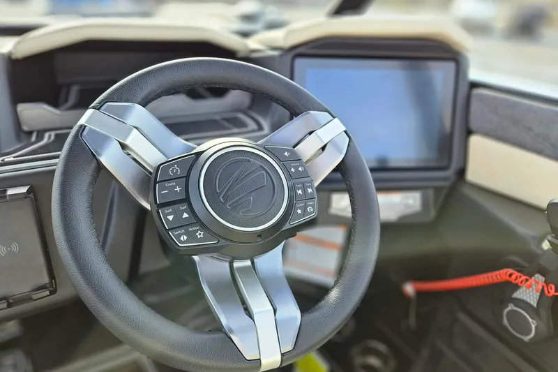 Slide: The Image of Steering wheel of 2026 Tigé 24RZX boat with control buttons and touchscreen display. - 8