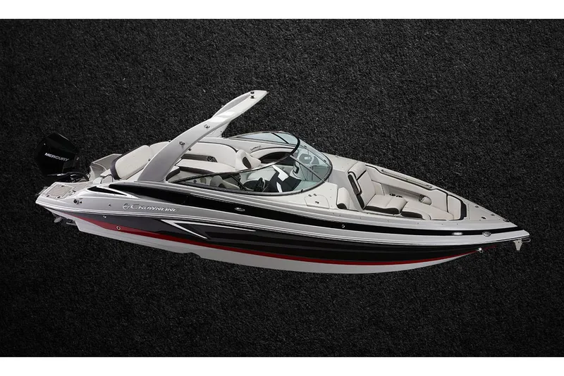 Slide: The Image of 2023 Crownline 270 XSS boat interior with seating and table by the water. - 10