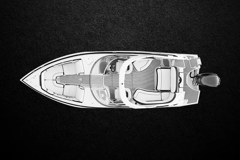 Slide: The Image of 2023 Crownline 270 XSS boat interior with seating and round table by the water. - 11