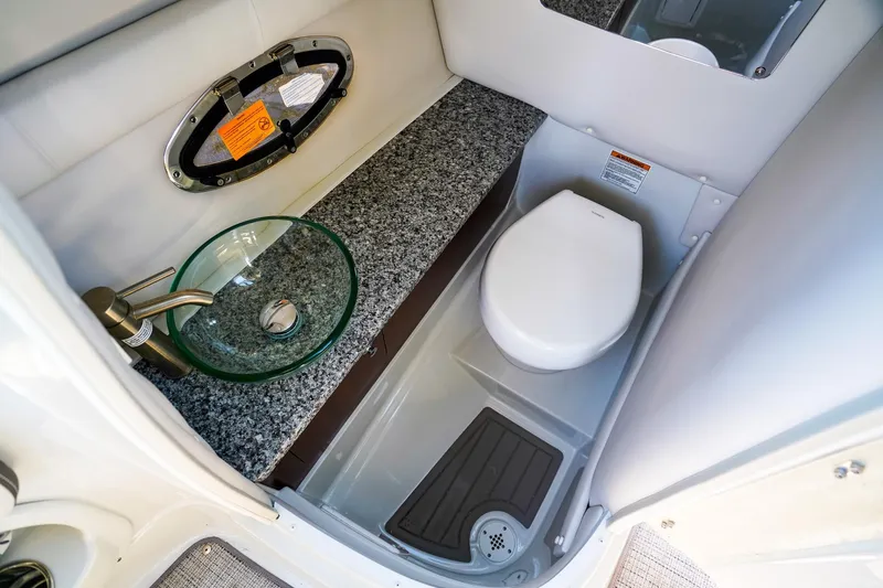 Slide: The Image of 2023 Crownline 270 XSS boat bathroom with modern sink and toilet. - 13