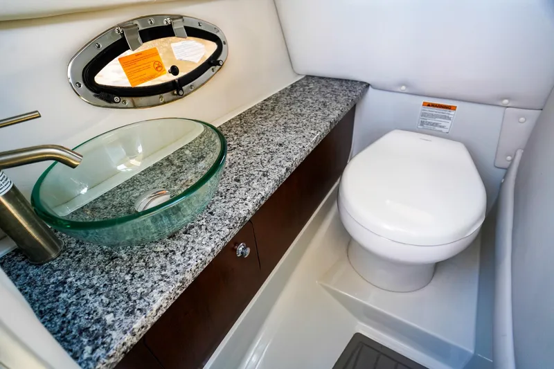 Slide: The Image of 2023 Crownline 270 XSS boat bathroom with granite countertop and glass sink. - 14
