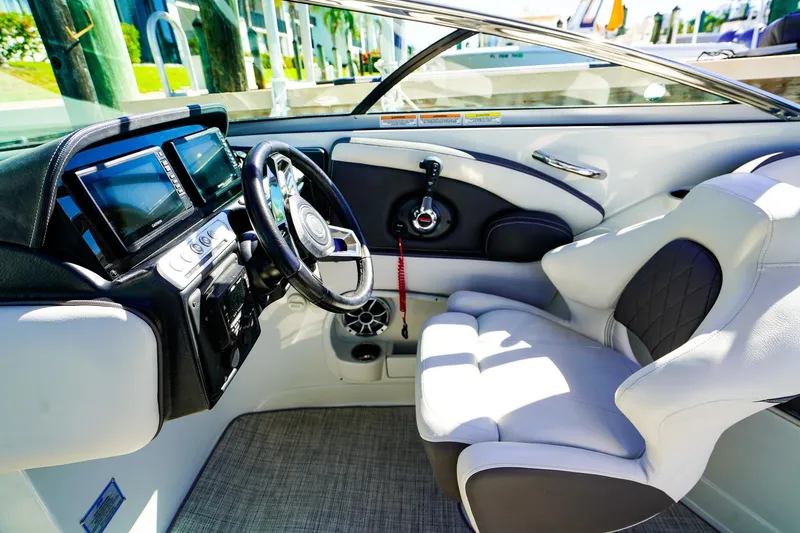 Slide: The Image of 2023 Crownline 270 XSS boat interior with modern dashboard and comfortable seating. - 15
