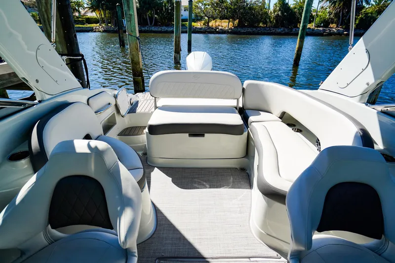 Slide: The Image of 2023 Crownline 270 XSS boat interior with luxurious seating and waterfront view. - 17