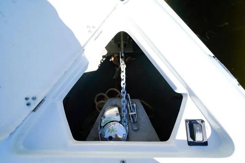Slide: The Image of Anchor compartment of 2023 Crownline 270 XSS boat with chain and winch. - 19