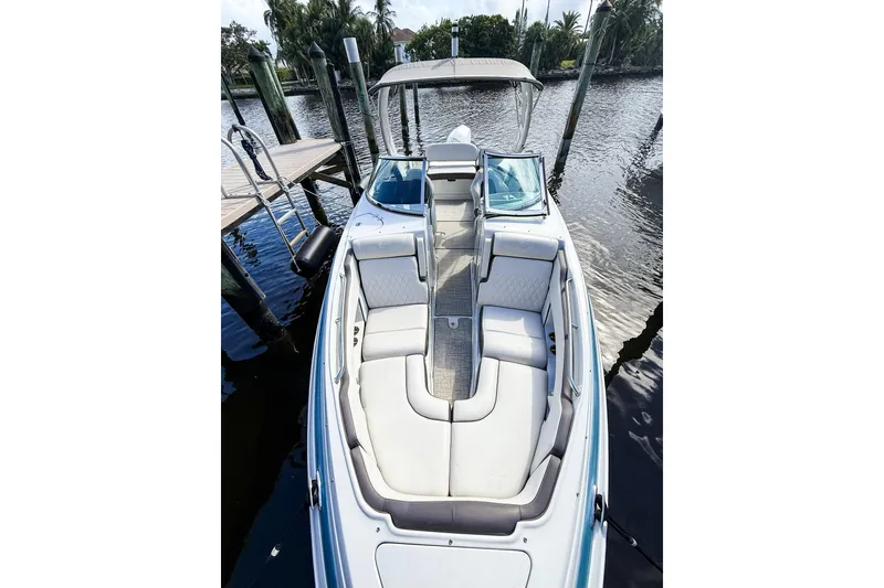 Slide: The Image of 2023 Crownline 270 XSS boat docked in marina, featuring sleek design and Mercury engine. - 3