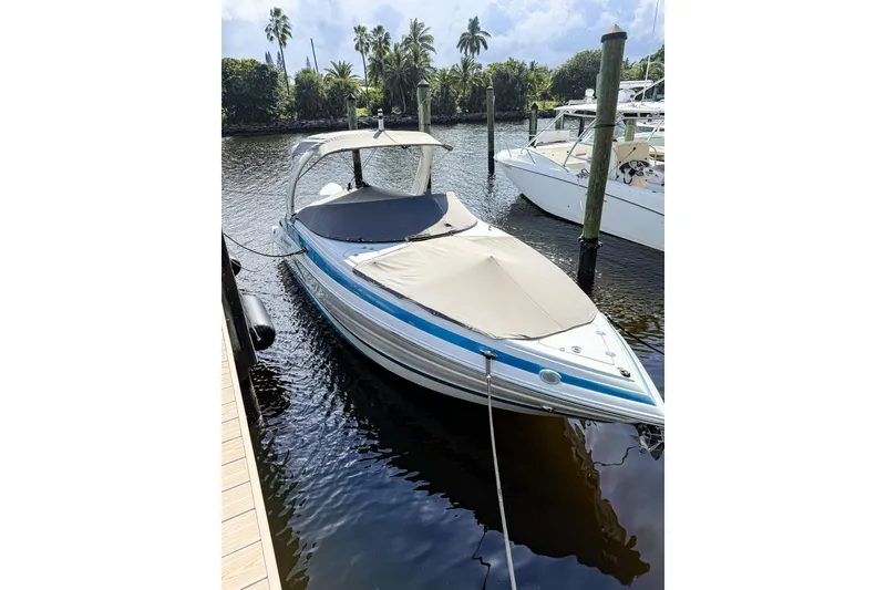 Slide: The Image of 2023 Crownline 270 XSS boat with outboard motor on water. - 6