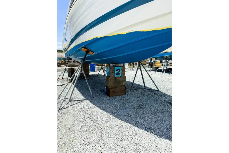 Slide: The Image of 2023 Crownline 270 XSS boat interior with luxurious seating by the water. - 8