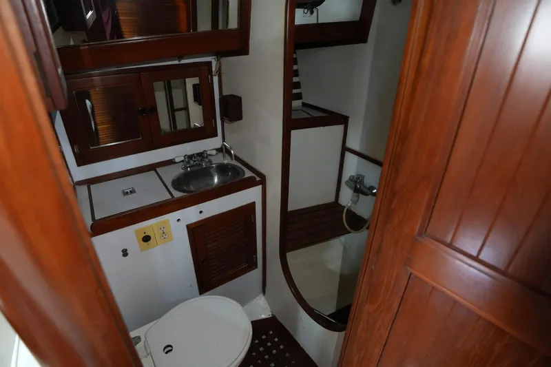 Slide: The Image of 1983 Tayana 37 yacht bathroom with wooden cabinetry and compact design. - 16