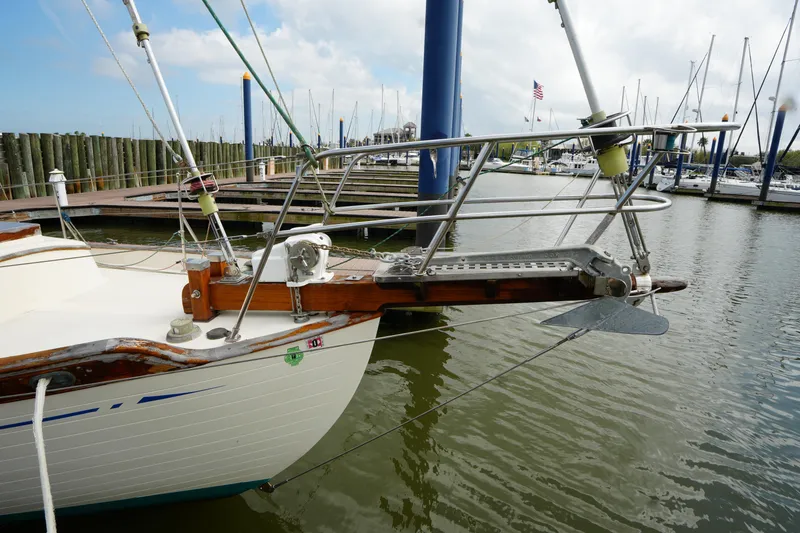 Slide: The Image of 1983 Tayana 37 sailboat docked at marina, featuring a sturdy bow and anchor. - 2