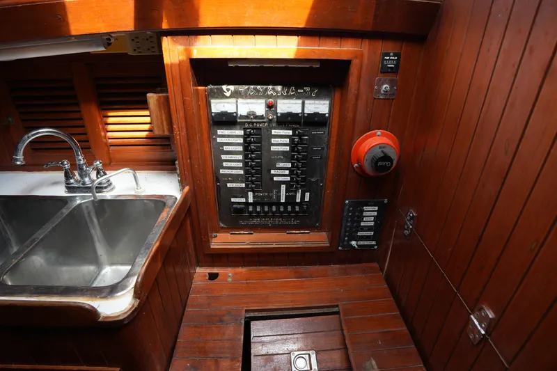 Slide: The Image of Electrical panel and sink in 1983 Tayana 37 yacht interior with wooden finish. - 22
