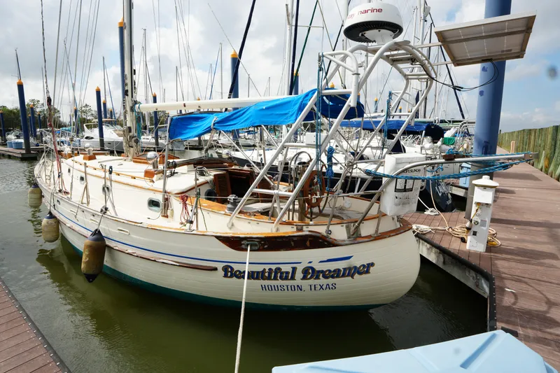 Slide: The Image of 1983 Tayana 37 sailboat docked in marina, named "Beautiful Dreamer," Houston, Texas. - 3