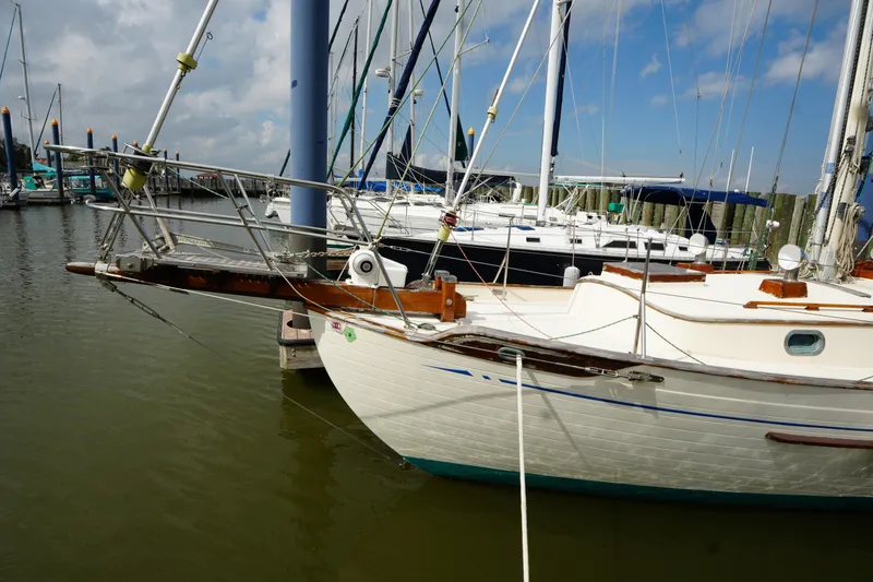 Slide: The Image of 1983 Tayana 37 sailboat docked at marina under blue sky. - 5