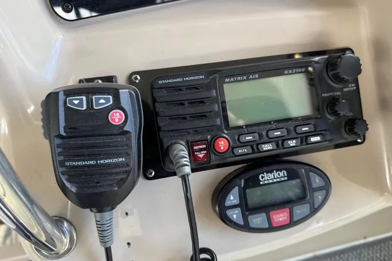 Slide: The Image of Standard Horizon radio and Clarion control panel on 2005 Sea Ray Sundancer 320 boat. - 12