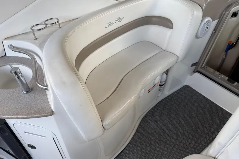 Slide: The Image of 2005 Sea Ray Sundancer 320 interior with white seating and built-in sink. - 13