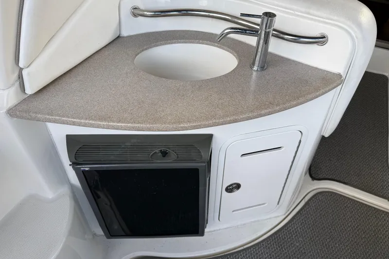 Slide: The Image of 2005 Sea Ray Sundancer 320 boat interior with sink and mini fridge. - 14
