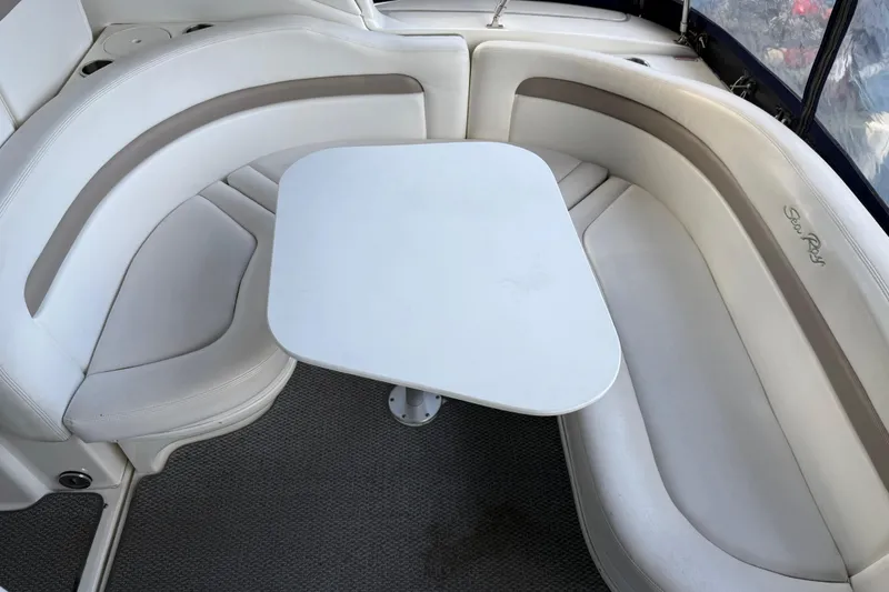 Slide: The Image of 2005 Sea Ray Sundancer 320 interior with white seating and table. - 16