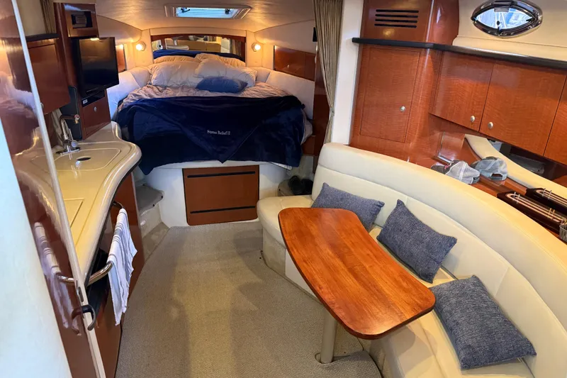 Slide: The Image of Interior of 2005 Sea Ray Sundancer 320 yacht with cozy seating and sleeping area. - 19